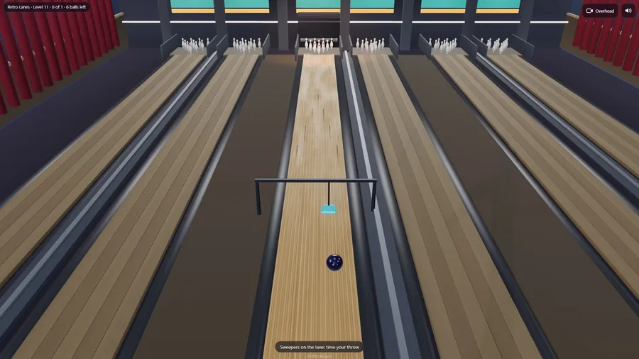 Overhead view of a ball rolling at a sliding sweeper on a gantry across the lane