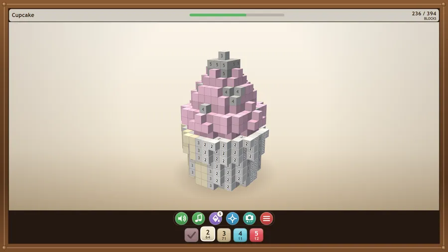A voxel cupcake half coloured: pink icing painted on top, grey numbered blocks still waiting below.