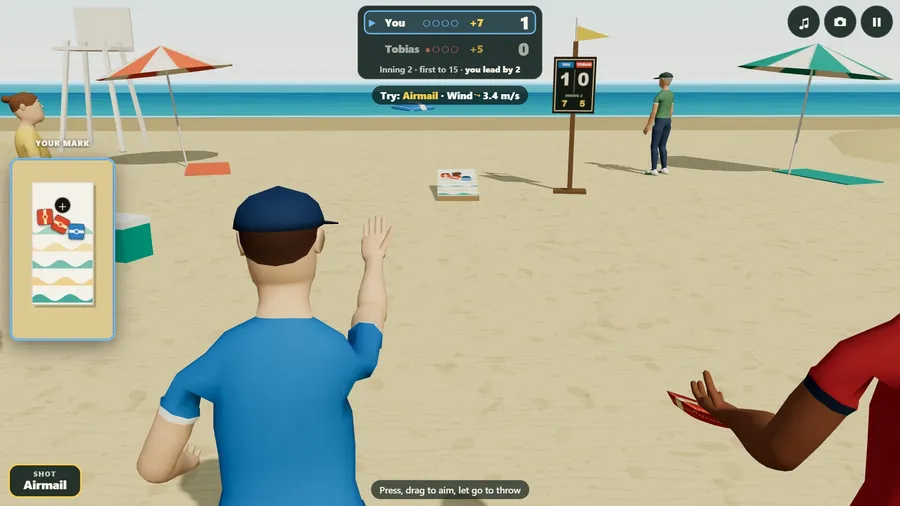 The beach over the shoulder: the arm is up after the toss and a blue bag flies toward the board on the sand, the sea behind.