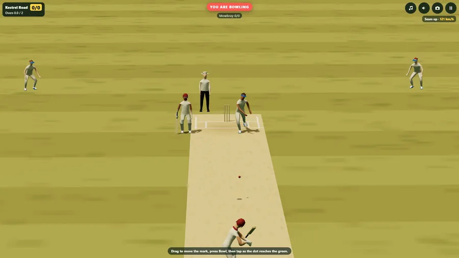 The television view from high behind the batter on a dry, dusty ground, with the ball on its way down the pitch.