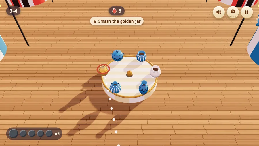 High view down onto stall 3-4 on the pier: blue jars and a gold one on a round stand; the challenge: Smash the golden jar