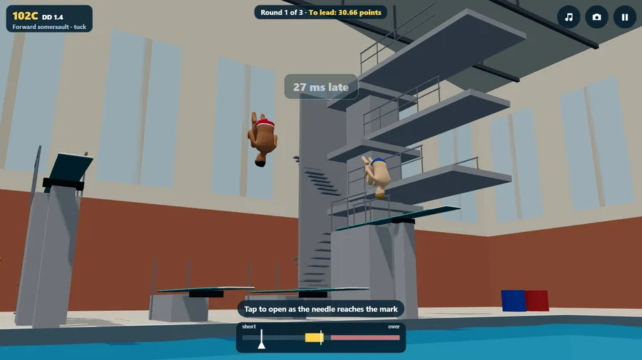 Two divers in the air side by side over an indoor pool, seen from the water.