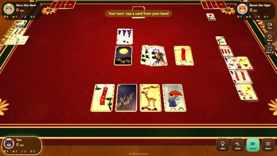 Close-up of the mat: your four cards lie flat before you, floor cards in the middle, captured piles at the sides.