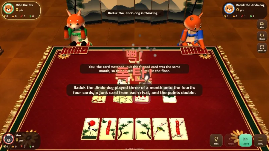 A special move with Korean letters bursting over the mat, as a fox and a dog play a month onto the cards on the floor.