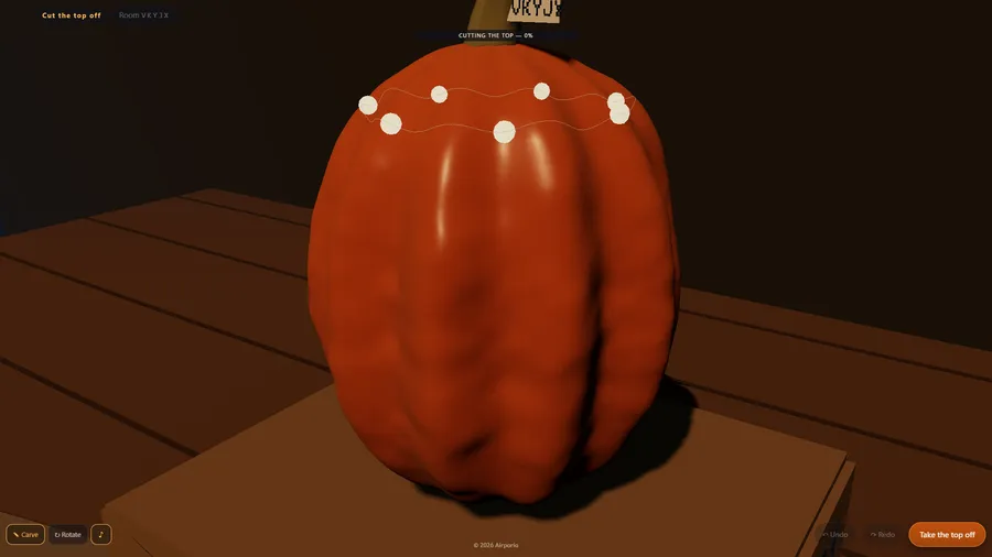 A whole orange pumpkin on a wooden table, with white dots along the dotted ring for cutting the top off, at 0%