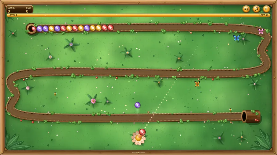 Level 2: a looping trail with a short chain of orbs at the top, shots in flight and a flower launcher at the bottom.