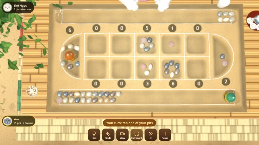 The chalk-on-sand board: a street-game grid drawn on the ground, with pebbles for stones and shells in the trough.