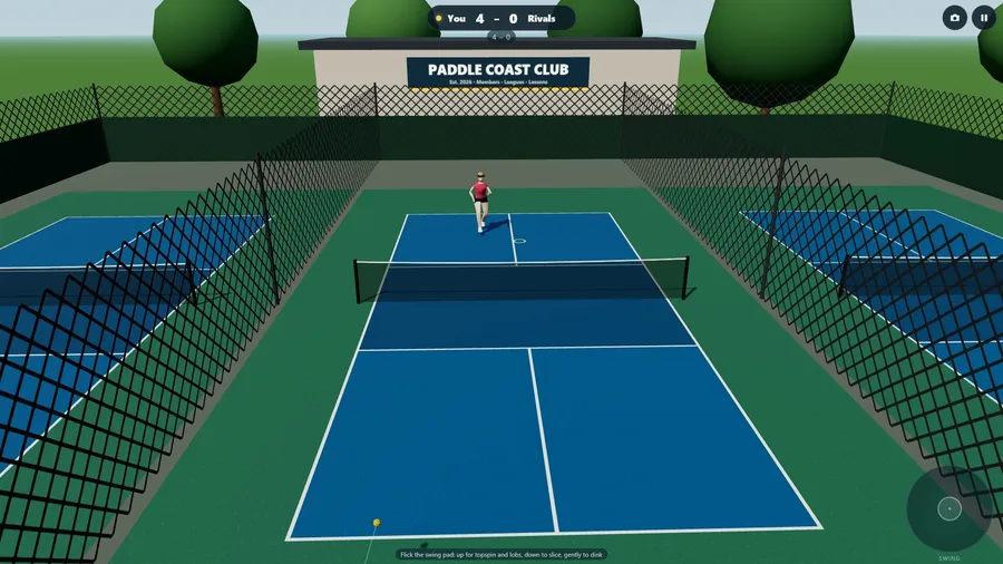The outdoor courts, with chain-link fences and trees, during a singles point.