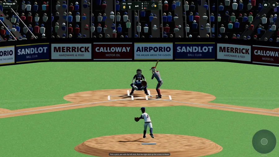 The TV camera from center field: the pitcher in front, batter, catcher and umpire at the plate, ad boards and crowd behind