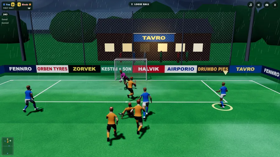 A wet night under floodlights: the keeper in pink has saved, players in blue and orange close in, a clubhouse beyond.