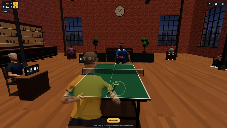 Over the shoulder at The Loft: the ball coming over the net, brick walls and tall windows on a city at dusk.