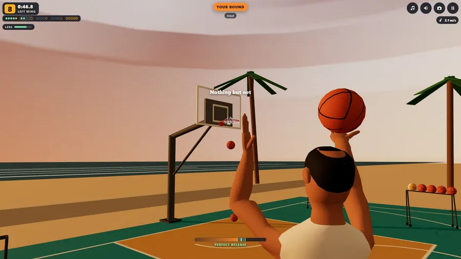 Close behind your shooter on the beach court at sunset: the ball raised over his head, the ring and two palms ahead.