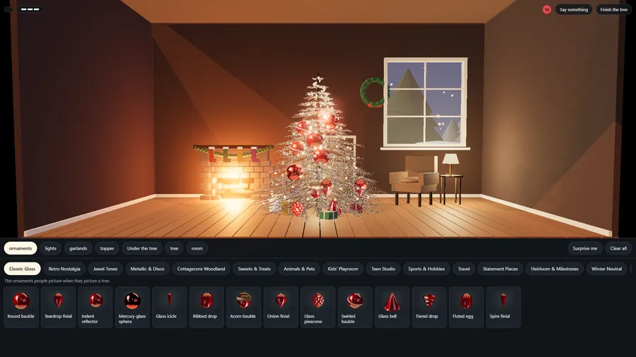A tree hung with red glass baubles in a fireplace room, above the Classic Glass shelf of ornaments